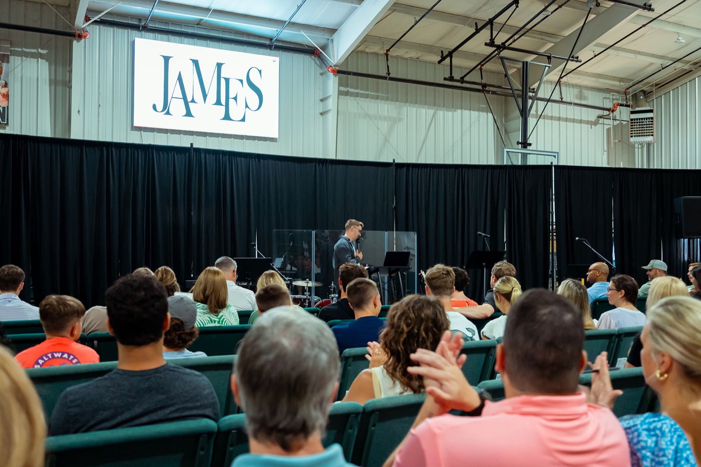 The room during a talk, with the James series title on the screen